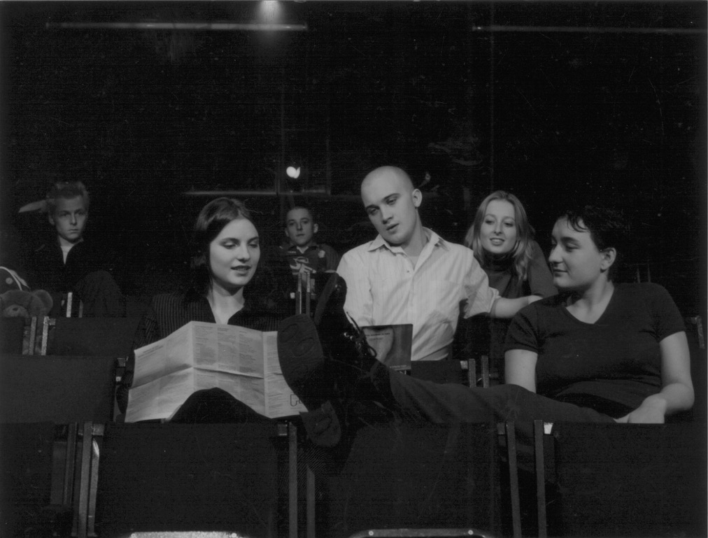 Black and white photo of the 6 founding members of Unlimited sat in Theatre auditorium seats.
